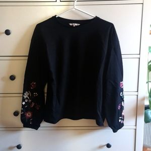 Black sweater with embroidered sleeves